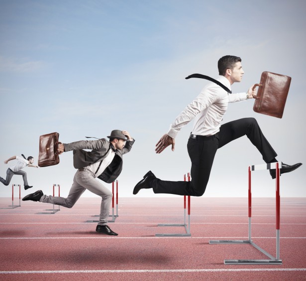 Business competition with jumping businessman over obstacle